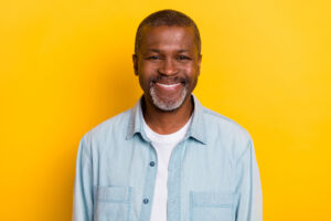 Man Smiling on Yellow Background