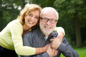 senior couple smiling implant dentistry concept