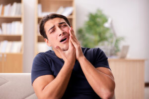 Man suffering dental emergency