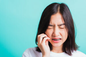 Woman with braces in pain