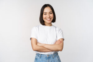 Smiling woman arms crossed on white background