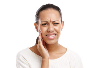 Woman clenching teeth in pain