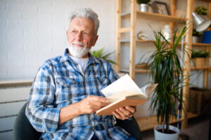 man reading book at home