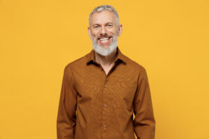 Man smiling on yellow background