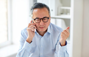 concerned businessman on cellphone