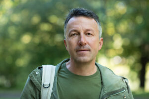 Man staring stoically outside