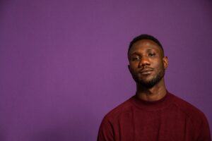 Man with blank expression on purple background