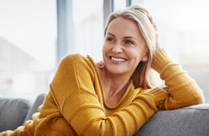 Woman smiling relaxing on sofa
