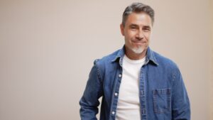 Casual man in blue shirt on white background