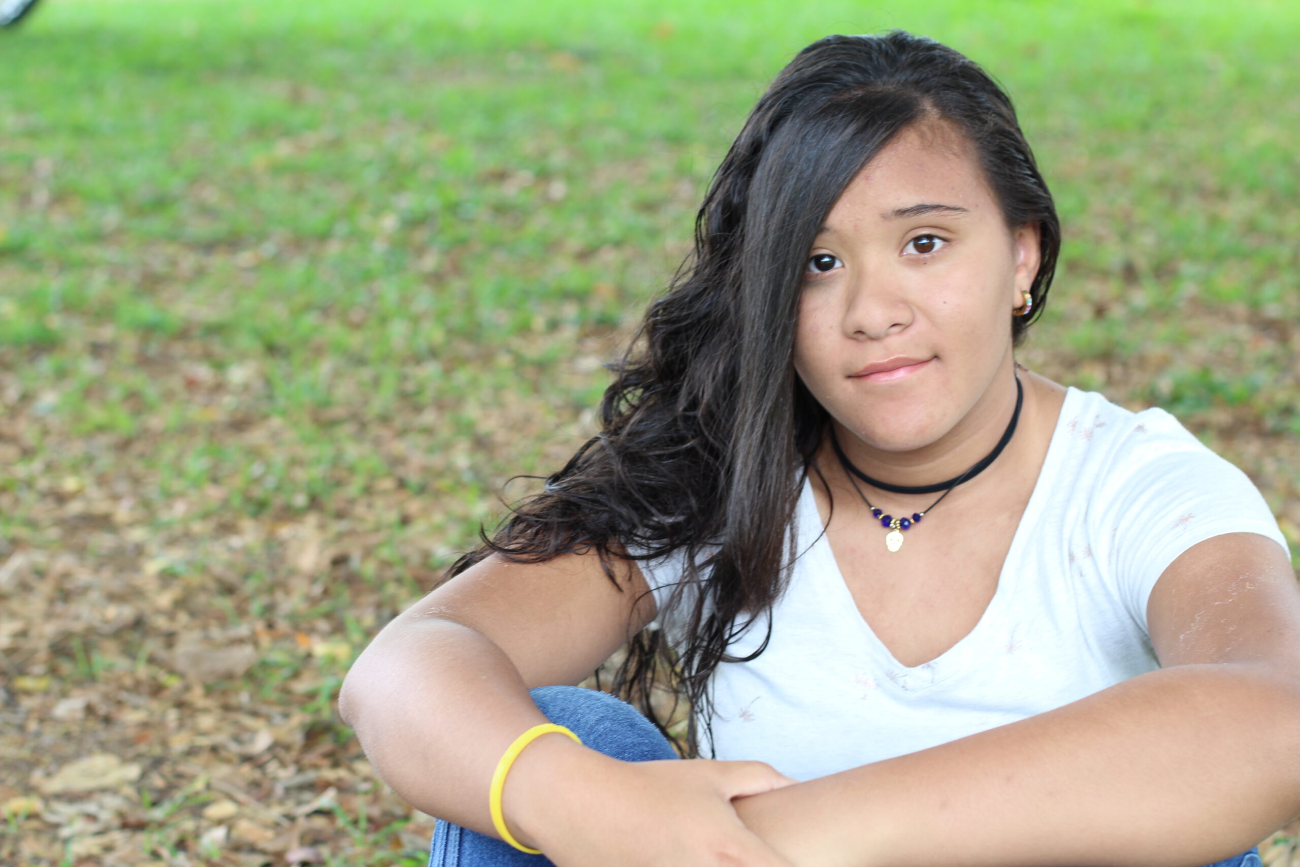 Teen girl sitting on grass