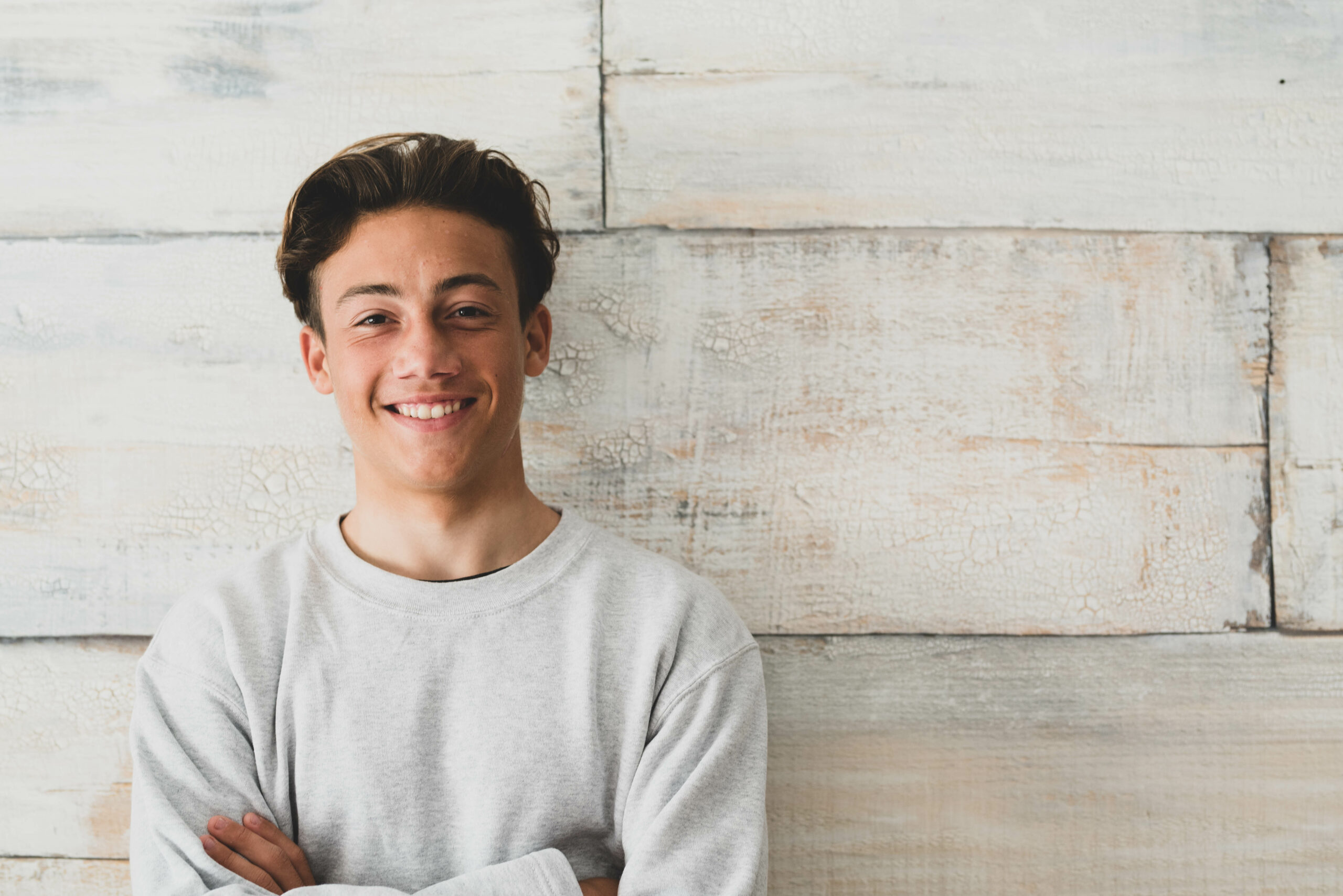 Smiling teenager on wall background