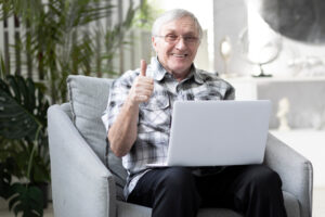 smiling man on laptop